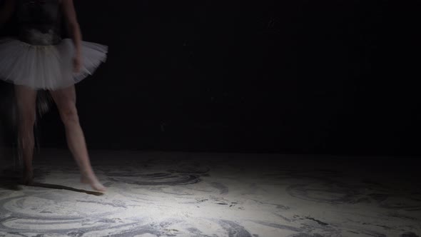 Graceful Woman in Tutu Throwing Dust in the Dark