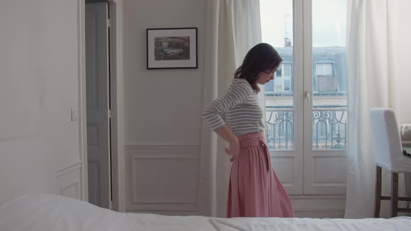 Beautifil girl dressing in the bedroom alt