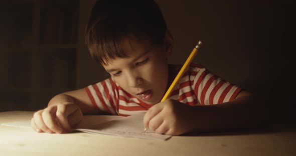 Left-handed Preschool Boy Using Pencil and Writing