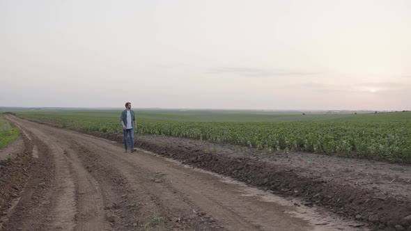 Far View of a Young Man That Walks on a Road alt