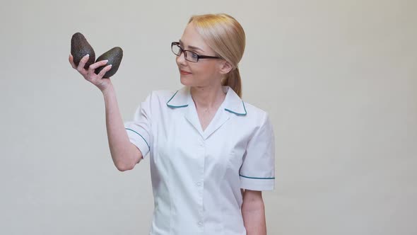 Nutritionist Doctor Healthy Lifestyle Concept - Holding Organic Avocado Fruit and Measuring Tape alt