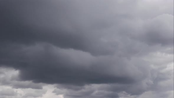 Timelapse Sky and Black Cloud. Dark Grey Storm Clouds. Dramatic Sky. Lighting in Dark Stormy Cloudy