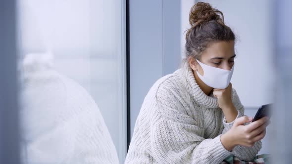 Woman Waits for Flight Near Window