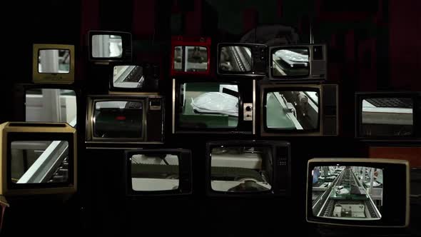 Laptop Computer Factory On Stacked Retro TVs. alt