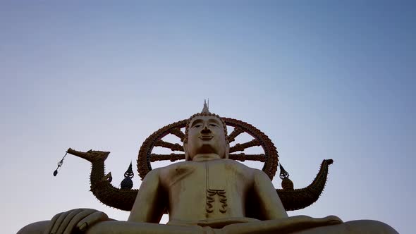 Time lapse of Big Buddha Temple on Ko Samui Thailand. Moving clouds, sunset sky. Buddhism. Pan up