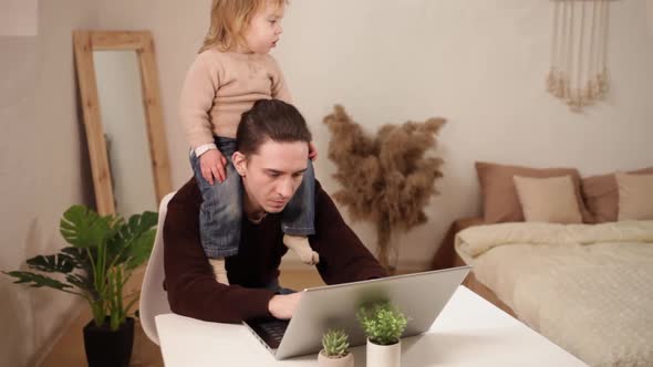 A Man Tries to Work Behind a Laptop at Home alt