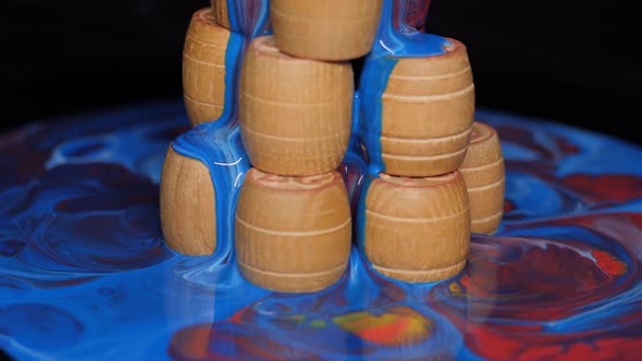 Wooden Barrels Doused with Multicolored Paints alt