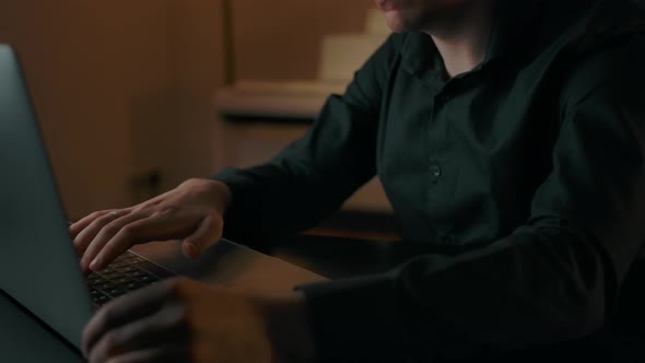 Serious Face of Caucasian Man Using Laptop's Touchpad for Searching Information alt