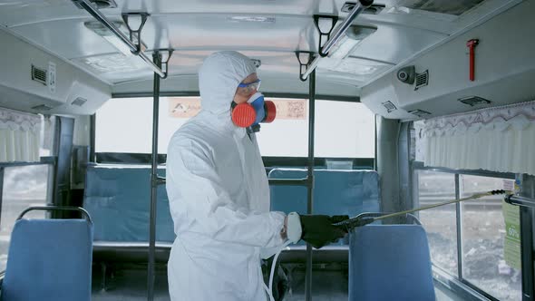 Disinfector in Protective Suit, Disinfection Inside Public Urban Transport, Bus alt