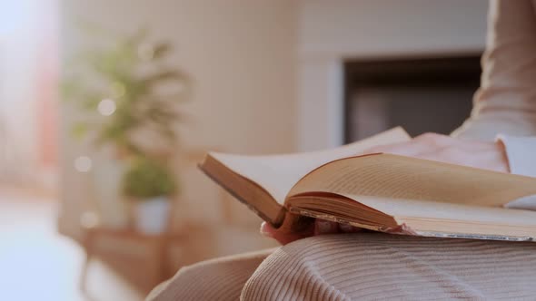 Sunset Book (2)Woman Reads Book at Home. Hand Turning Pages of a Book