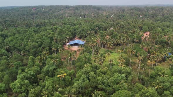 A beautiful aerial view of the house in a thick forest alt