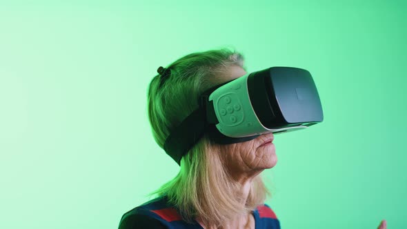 Old Greyhaired Woman Using VR Headset alt