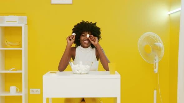 African Woman Is Playing With Marshmallow alt