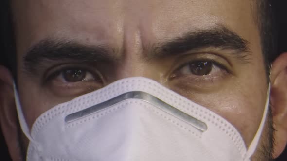 Close-up of Man's Face Wearing a Mask and Serious Expression alt