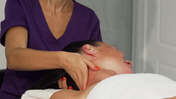 Young Happy Female Therapist Giving Massage To a Client alt