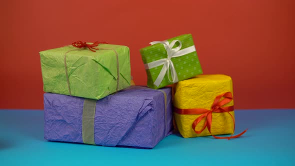 Presents on Color Background Hands Took Gifts Box Holiday Celebration Concept