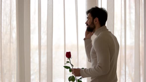 Man Holding Rose and Phone alt