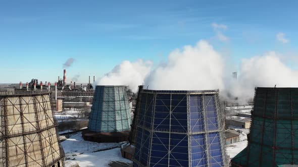 Flying Over the Plant Producing Thermal Energy with Large Pipes. Aerial Shot. Ecology Problem