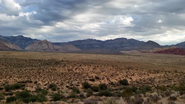 Red rock panorama under dramatic dark blue sky alt