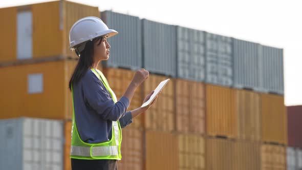 Worker woman checking and control loading containers box from cargo