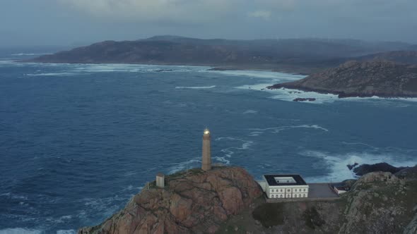 Lit Lighthouse at Dusk in Cape Vilan Galicia Spain Aerial View