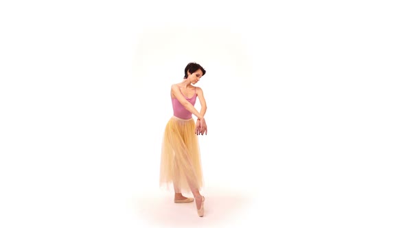 Young Ballerina Spinning and Making Dance Trick Known As Battements Tendus, in the Studio on a White