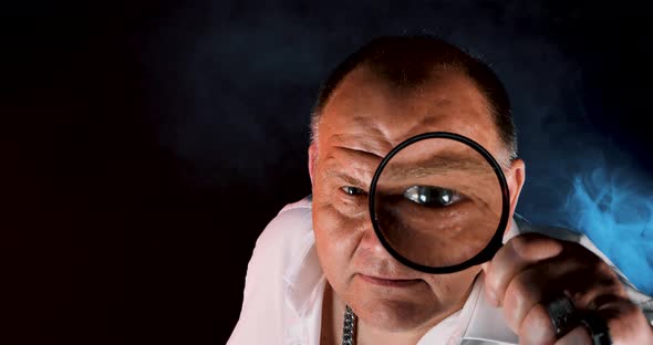 Mature Bandit With Magnifying Glass Looking At The Camera And Holding A Baseball Bat alt