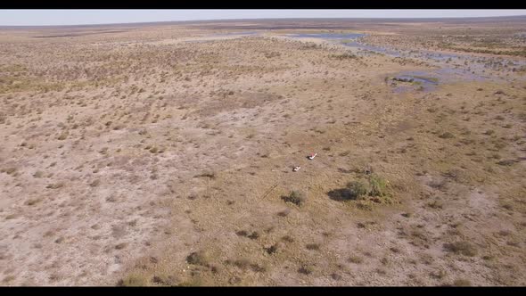 Vehicles Traveling in Vast African Plains