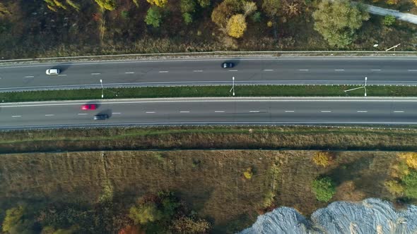 Aerial Drone Footage. Fly Over Autobahn Near Forest Top View Shot