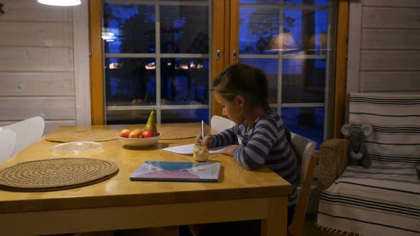 Pretty School Girl at Home, Writing a Homework. Child Sitting at Table and Write a Letter With Pen.