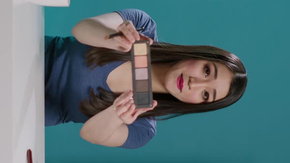 Vertical Video POV of Influencer Filming Makeup Tutorial with Eyeshadow Palette alt