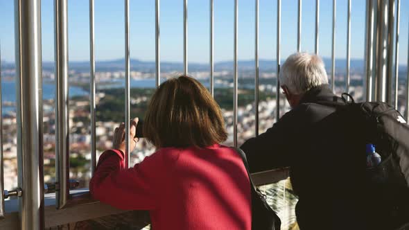 Family Couple of Old Travelers Spends Vacation Time Together at Cristo Rei Deck