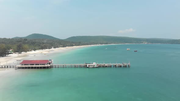 Old Wooden Pier standing above calm shallow turquoise water in Koh Rong Sanloem, Cambodia alt