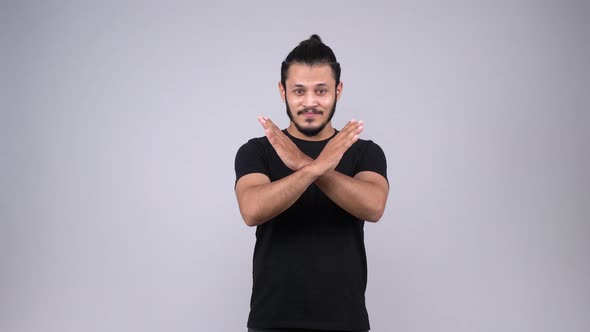 Frustrated Indian man making NO symbol alt
