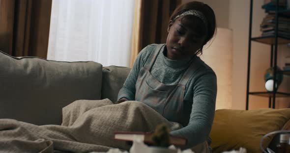 A Woman Looks Through the Pages of a Book Curious About the Next Pages alt