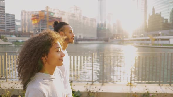 Cute African American couple walk together along the Chicago River  alt