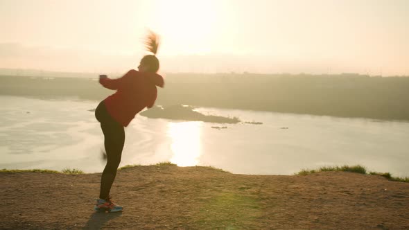 Active Woman Practicing Fighting Exercises at Sunset