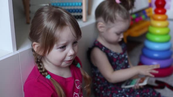 Little Girl Crying While Sister Playing with Smartphone.