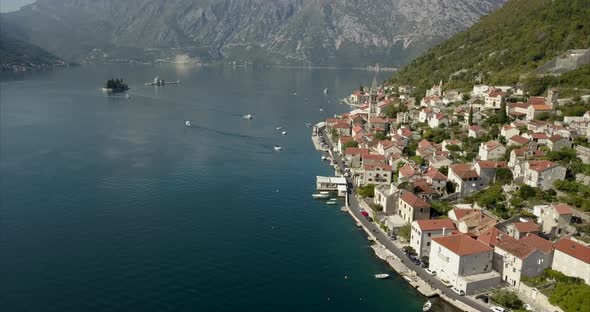 Aerial shot of Perast in on the bay of Kotor in Montenegro during a sunny day. alt