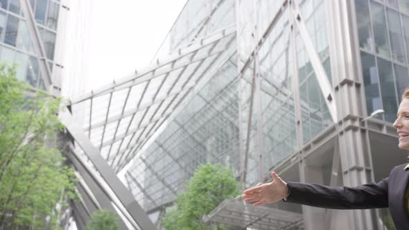 Businesswoman shaking hands with Businessman outdoors in the city