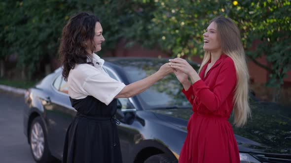 Excited Gorgeous Young Daughter Hugging Mature Mother with Surprised Facial Expression Receiving alt