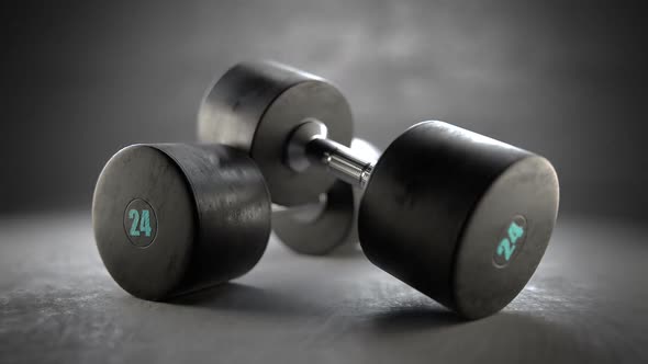 Pair of dumbells isolated on a grey concrete floor. Strenght, fit concept. alt