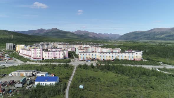 Aerial view of a small town among forests and hills. 01 alt