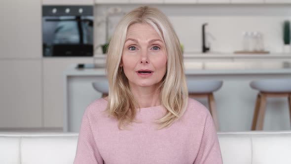 Frightened By the Terrible News Senior Woman Covering Mouth with Hand and Looking Terrified alt