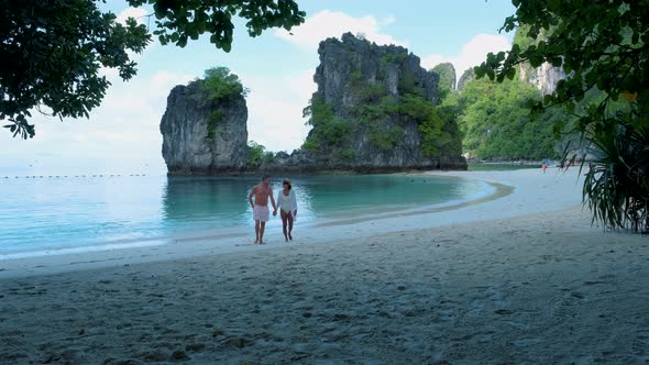 Couple Men and Woman on the Beach of Koh Hong Island Krabi Thailand Asian Woman and European Men on alt