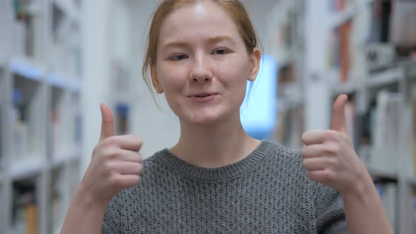 Thumbs Up by Young Woman in Cafe alt