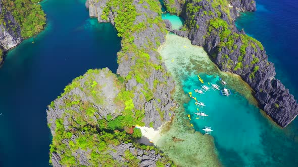 Fly Around Tourist Boats Near the Mountains with Beautiful Big and Small Lagoons in El Nido, Palawan alt