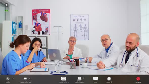 Group of Specialist Doctors Having Video Meeting alt