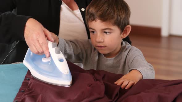 Mother and Son ironing clothes together