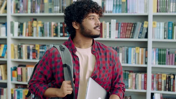 Happy Confident Indian or Arabian Male Student of University in Stylish Wear with Backpack and alt